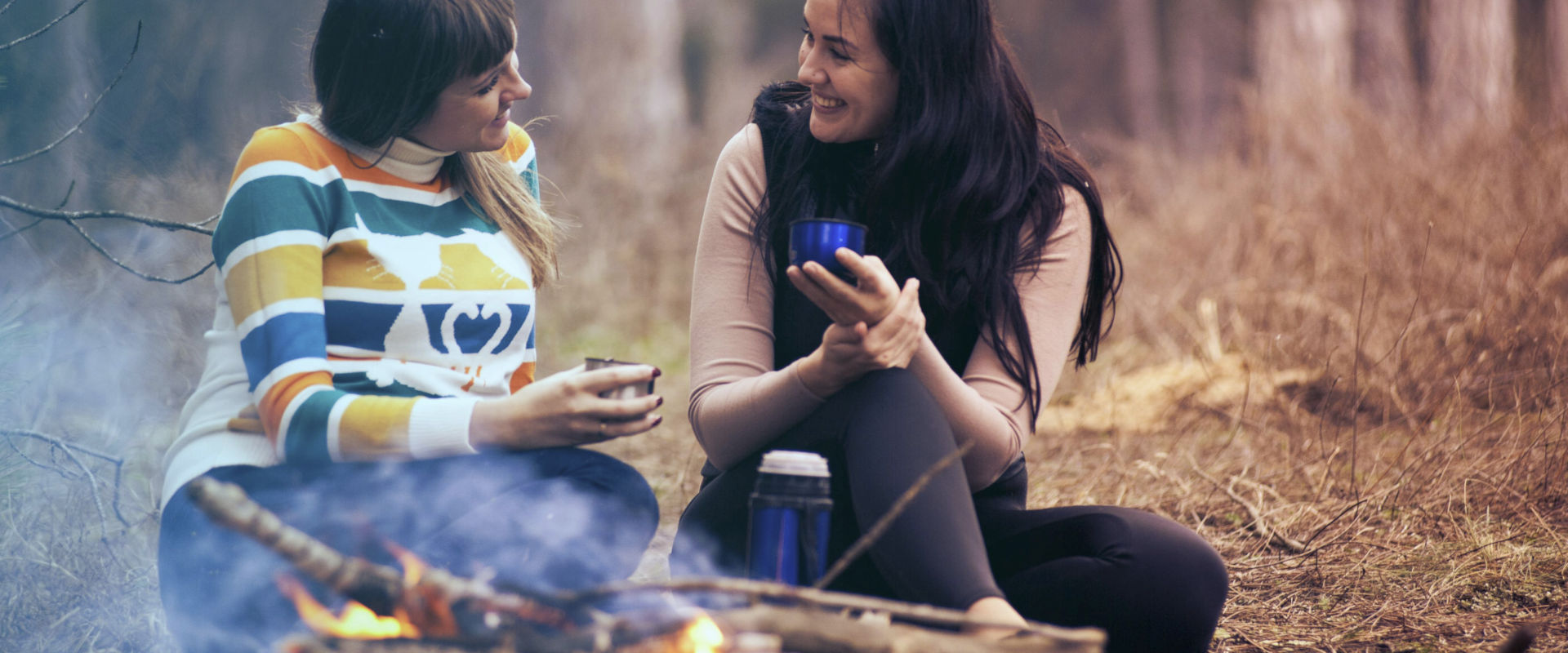 2 women by a campfire